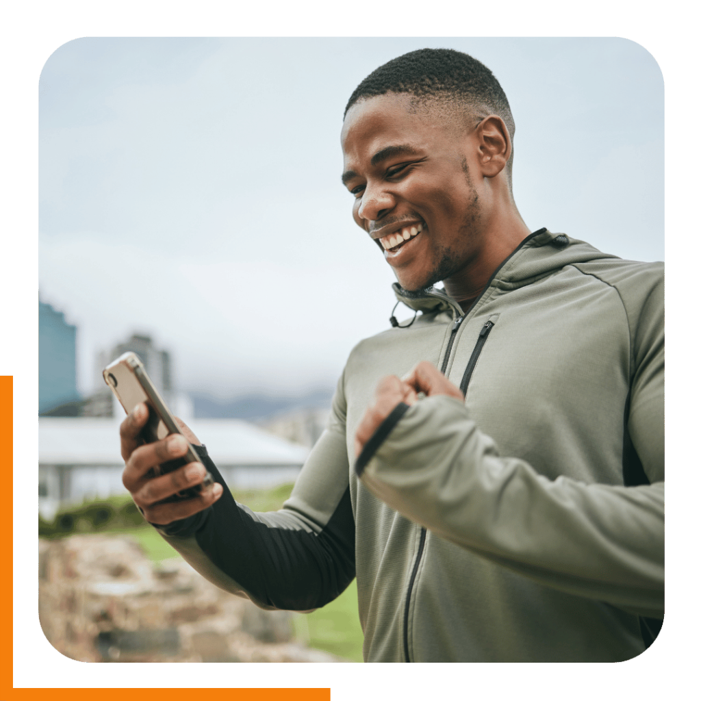 Man smiling after a run looking at his online training plan.